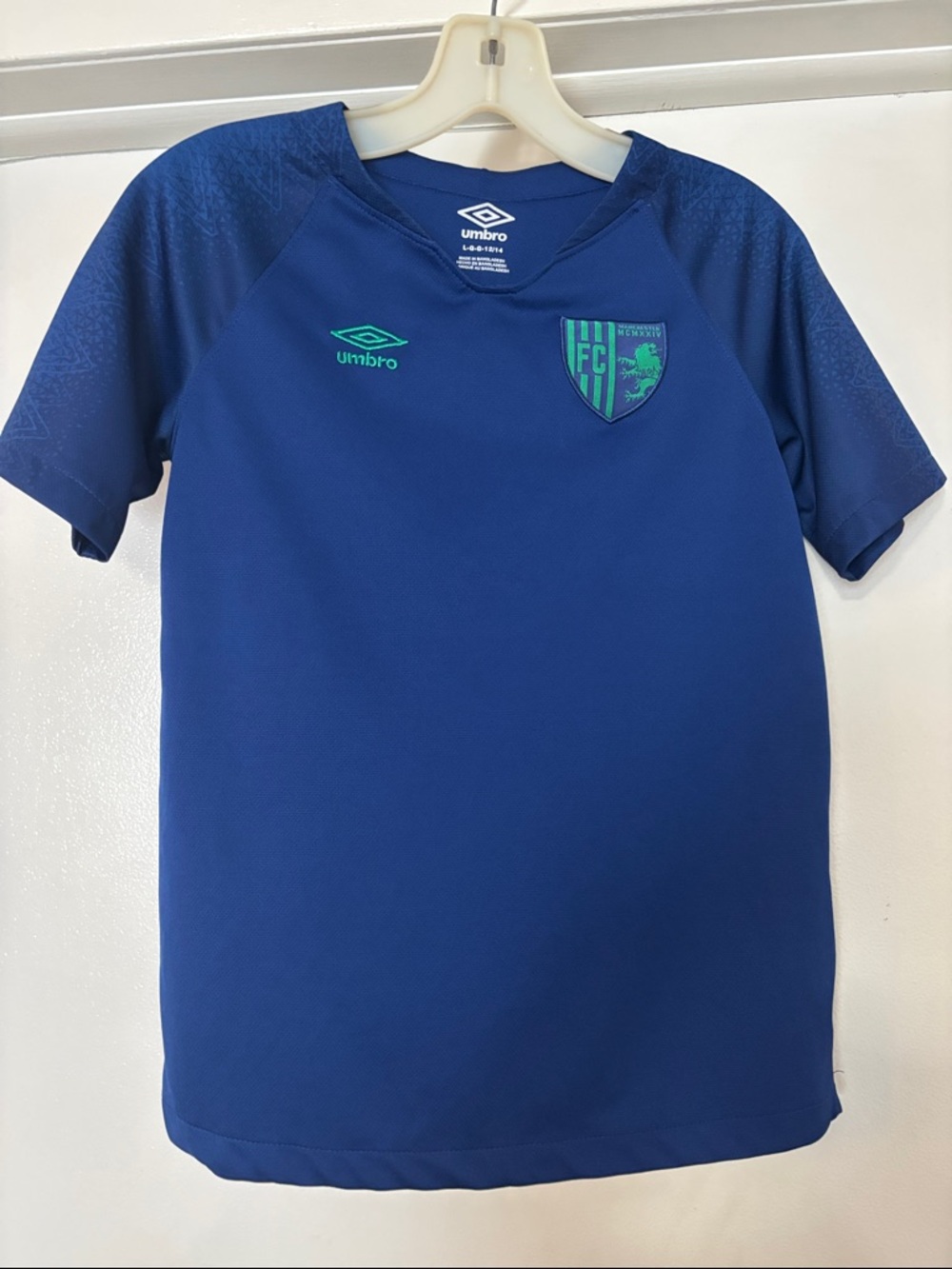 Umbro Manchester Kids Blue Soccer Jersey with Teal Accents